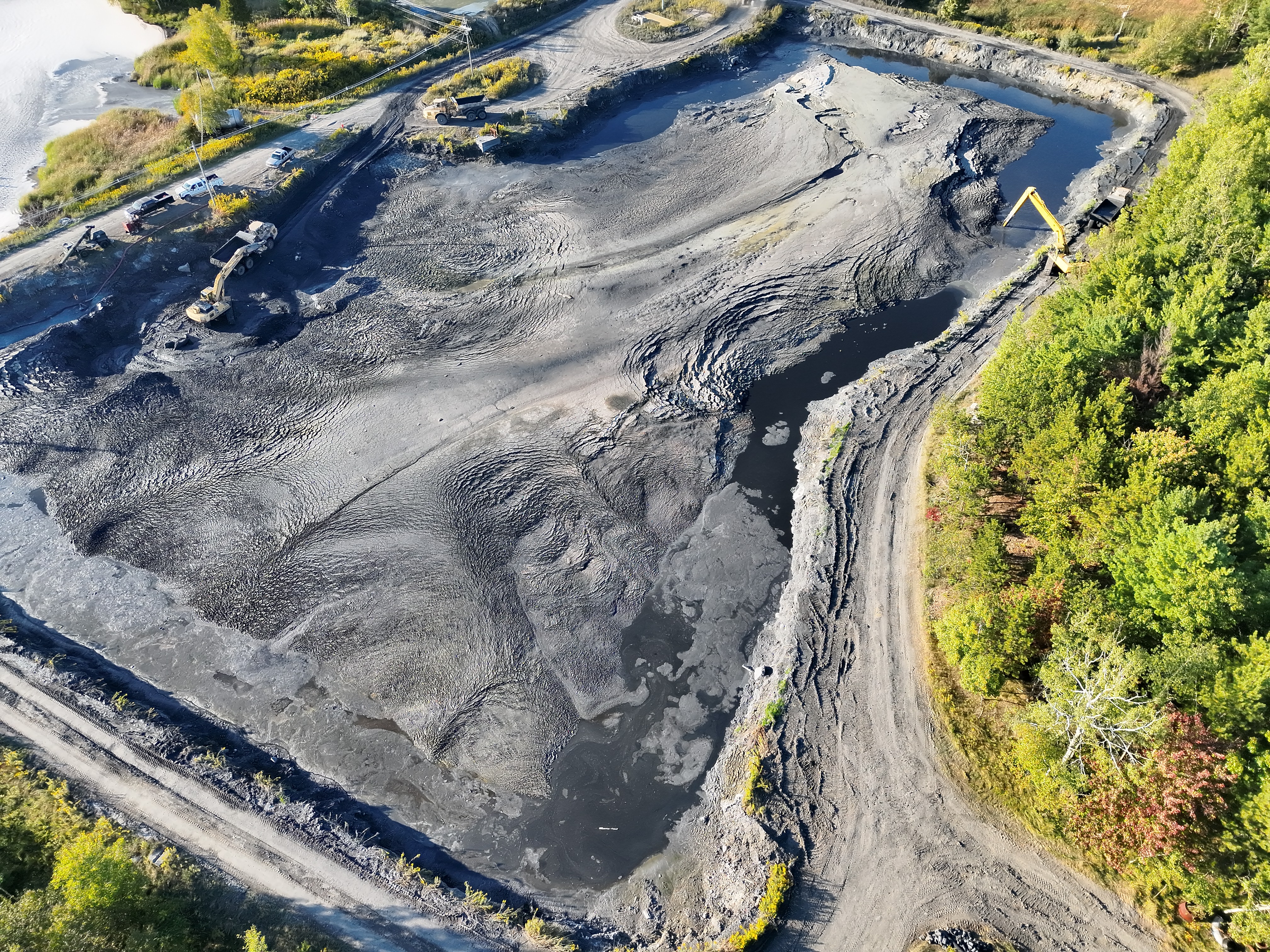 Aerial overview of active industrial lagoon earthwork