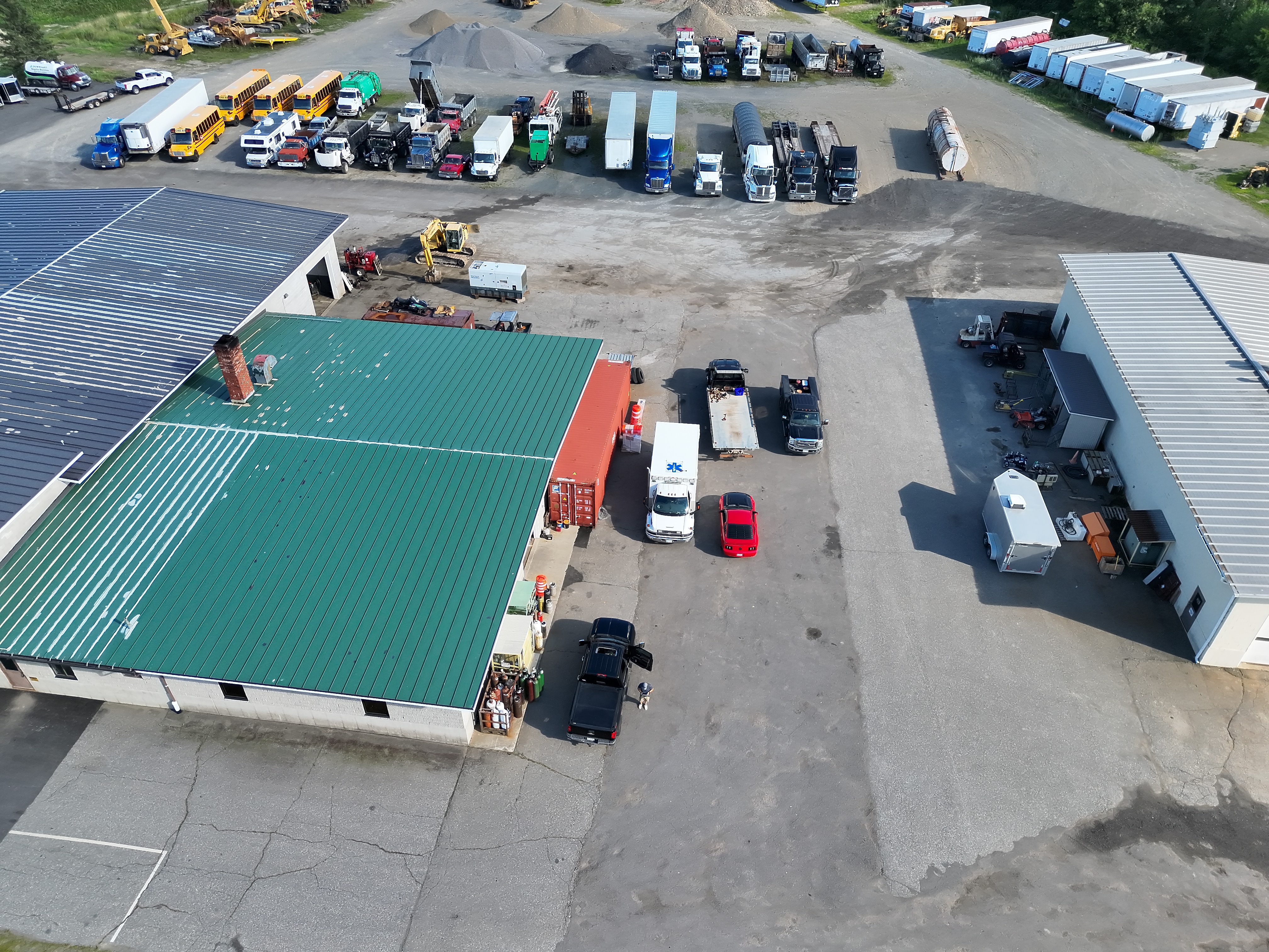 Aerial overview of a commercial industrial yard and buildings